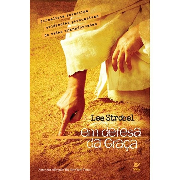 Livro Em Defesa da Graça, de Lee Strobel, capa amarela com mão apontando para areia. — Plenitude