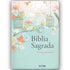 Bíblia Sagrada NVI, capa dura azul-claro com galhos, pássaros amarelos, gaiolas e flores coloridas. — Plenitude