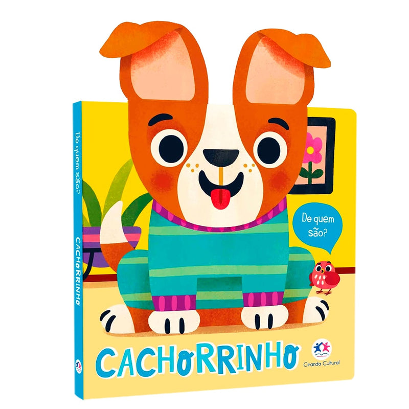 Livro Cachorrinho De Quem São?, capa amarela com ilustração de um cachorro usando suéter azul. — Plenitude
